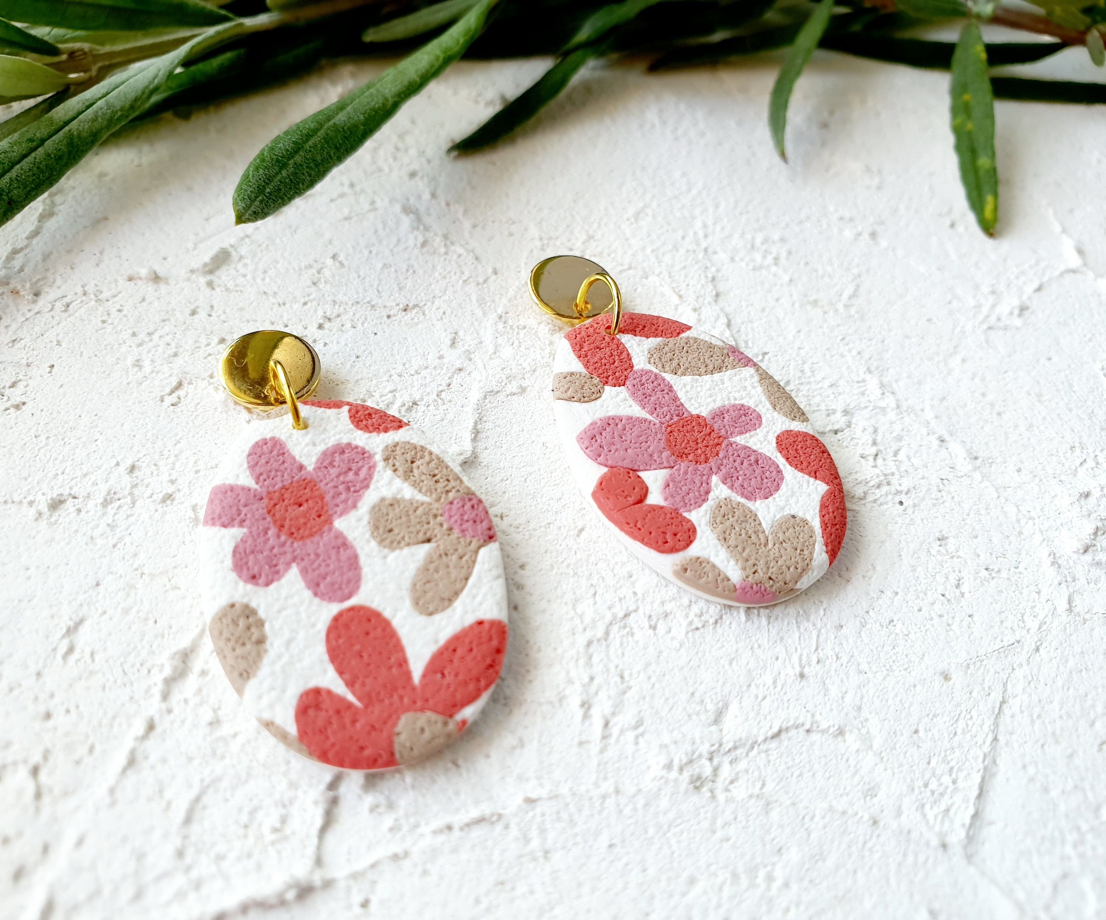 Pink flowers on white, big pebble