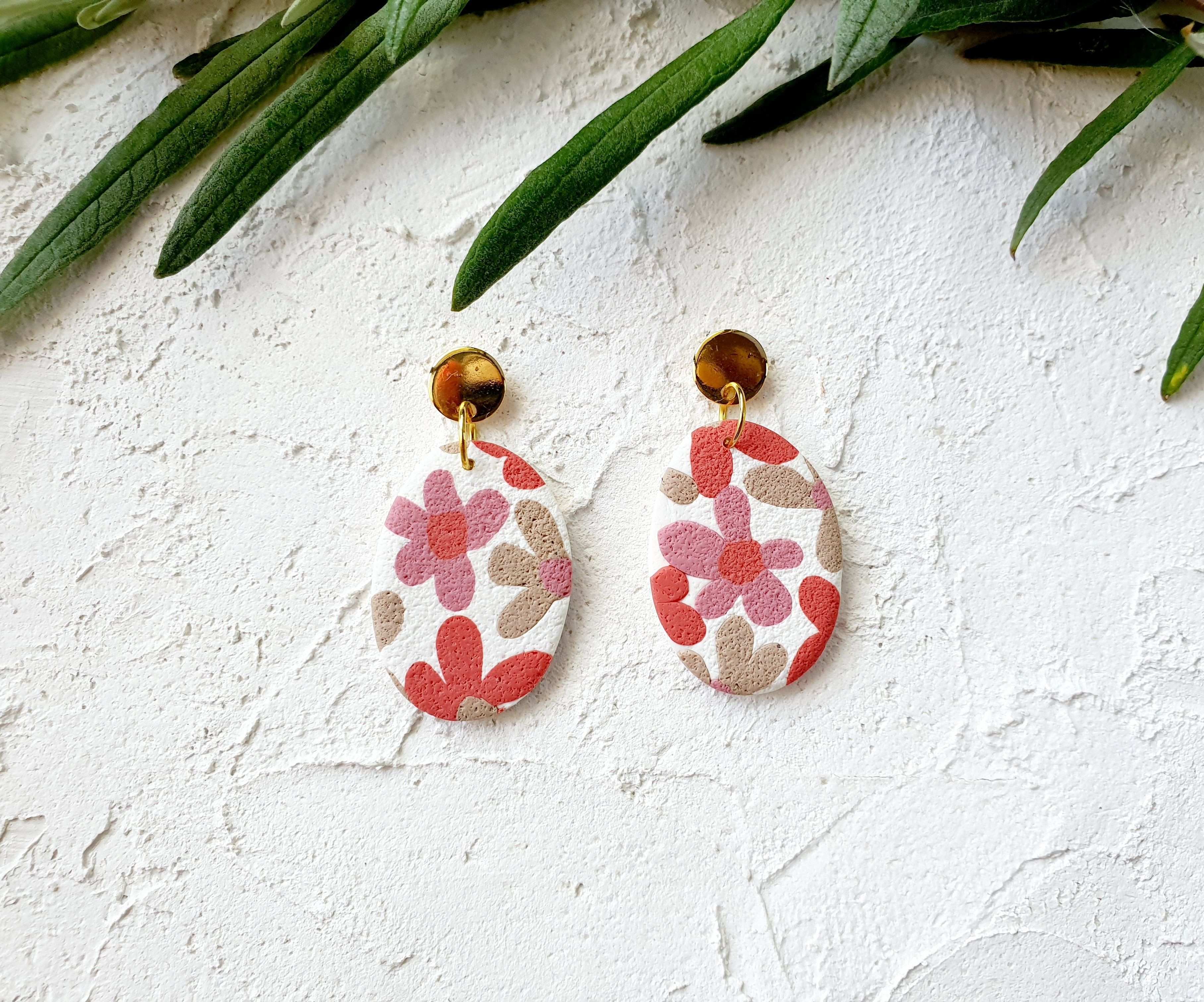 Pink flowers on white, big pebble