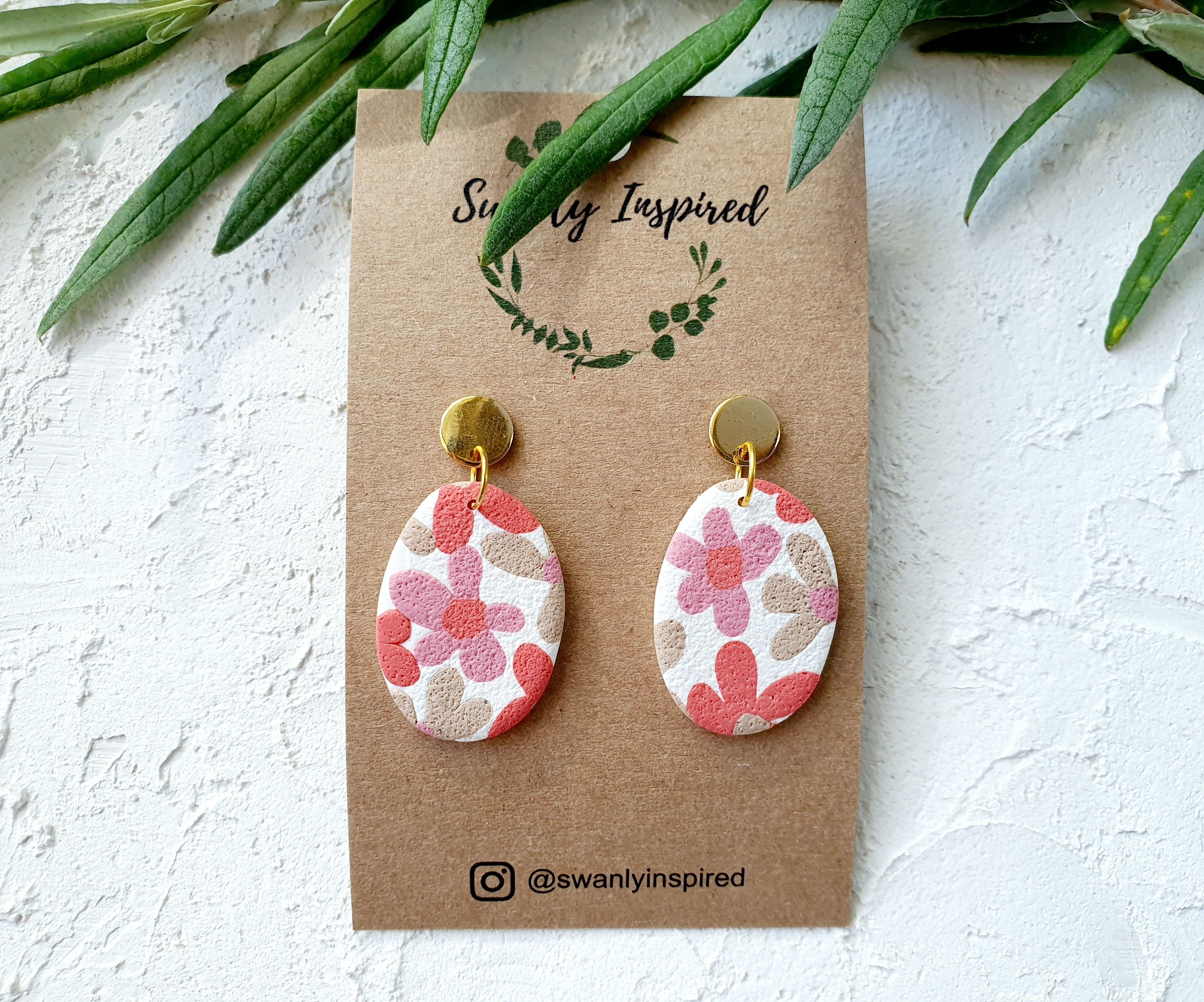 Pink flowers on white, big pebble